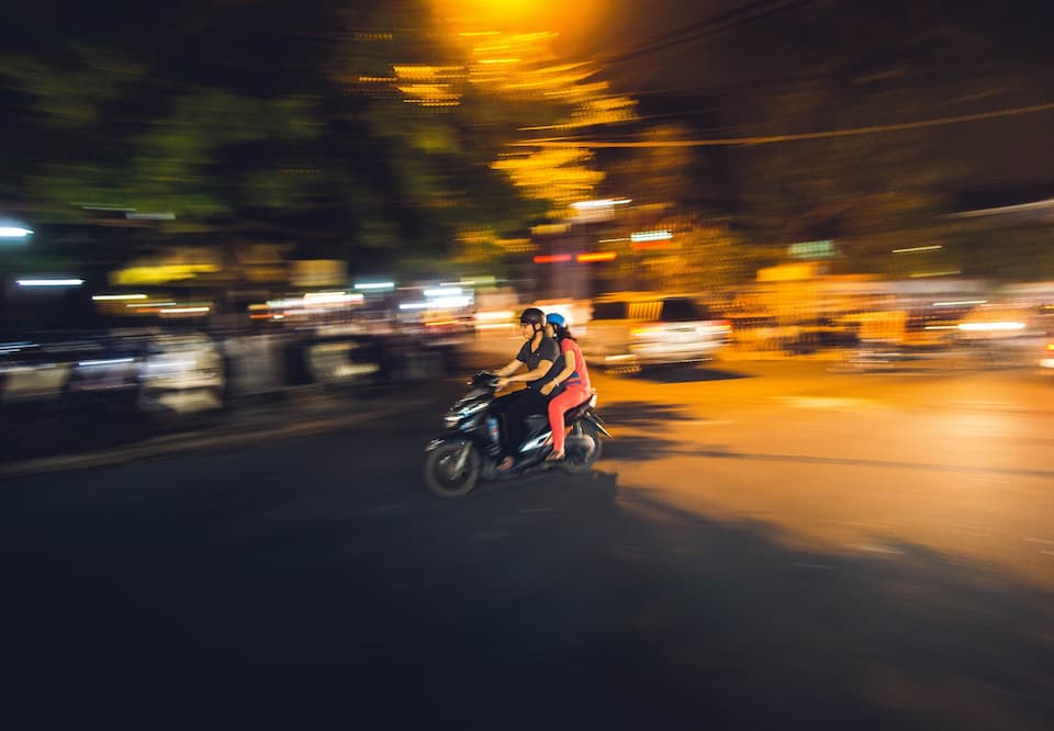 People sitting on Vespa
